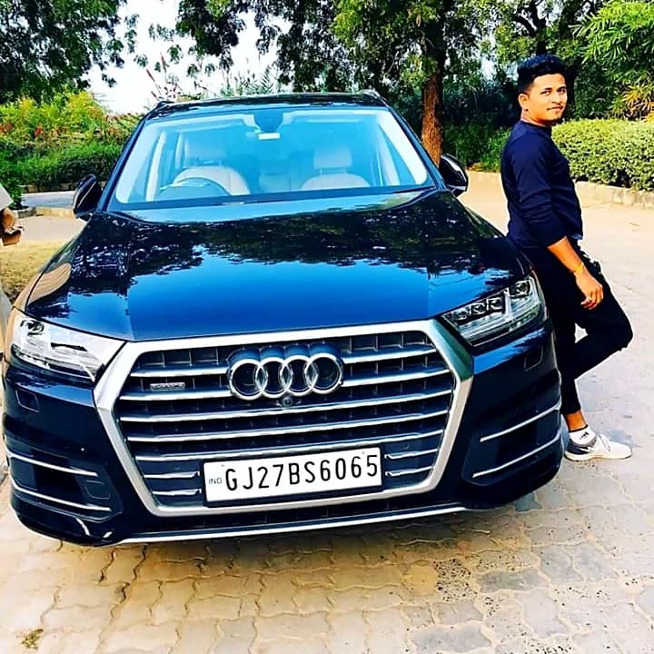 Dark blue Audi Q7 parked under trees